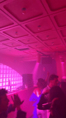 DJ performs at Paris nightclub under colorful lighting