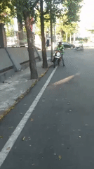 Morning traffic and street life on a Makassar road