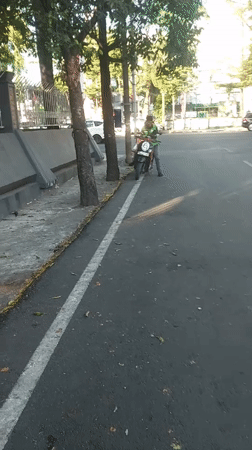 Morning traffic and street life on a Makassar road