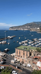 Tourists document sunny afternoon views across Sorrento's coastline and landmarks