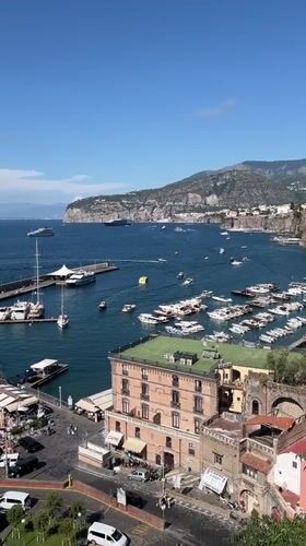 Tourists document sunny afternoon views across Sorrento's coastline and landmarks