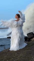 Woman in white feathered dress spotted at Russian waterfall