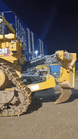Caterpillar bulldozer parked at night in rural Kazakhstan
