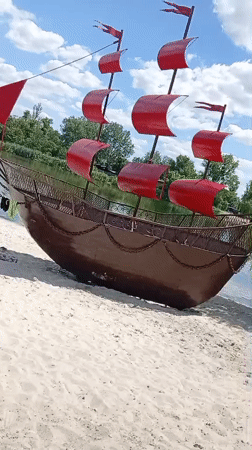 Public sculptures and street art along a riverside promenade