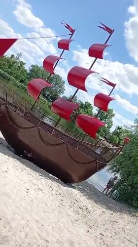 Public sculptures and street art along a riverside promenade