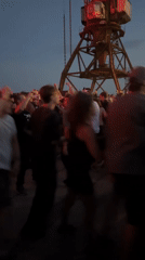 Outdoor dance party glows under pink and red lights in Riga