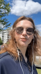 Woman walks through Belgrade neighborhood near apartment buildings