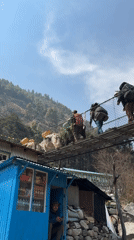 Trekkers cross suspension bridges over glacial rivers in Khumjung