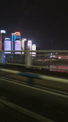 Night drive captures Chongqing's illuminated skyline from moving vehicle