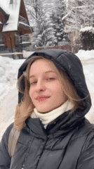 Woman films herself in snowy Zakopane street scene
