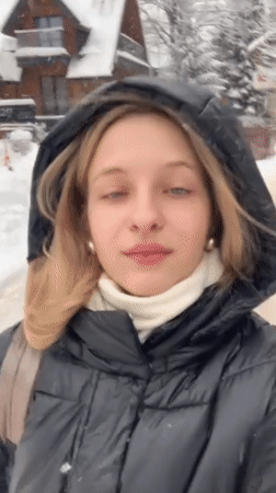 Woman films herself in snowy Zakopane street scene