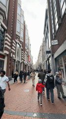 Woman films herself walking Amsterdam pedestrian street
