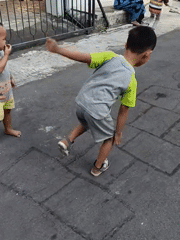Hopscotch on chalk-drawn grid in Kediri City