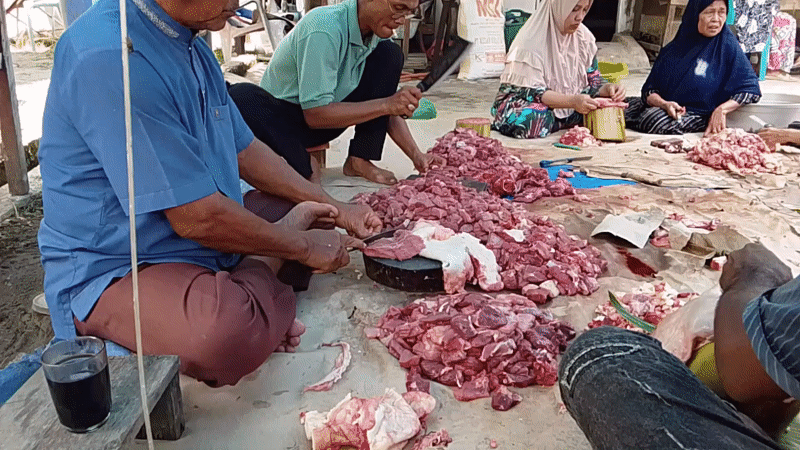 Early morning communal meat preparation and cooking in Gampongjawa