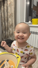 Toddler enjoys mealtime at home in Astana, Kazakhstan