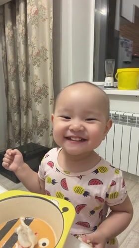 Toddler enjoys mealtime at home in Astana, Kazakhstan
