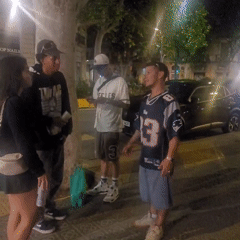 Young people skateboard and socialize on Barcelona streets at night