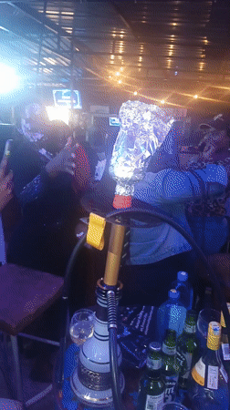 Evening celebration with cake at Nairobi bar gathering