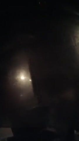 The video, presumably taken at night, features blurry glimpses of streetlights seen through a wet or frosted window. The camera appears to be moving. At times, the scene is almost completely dark, with only faint glimmers of light breaking through. The overall impression is of limited visibility due to the poor weather conditions.