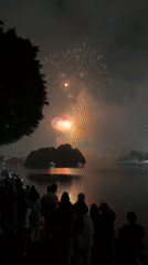 Crowds watch colorful fireworks display over Hanoi waterfront
