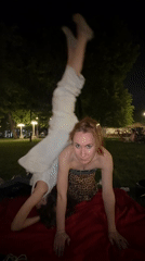 Two women practice nighttime yoga in Moscow park