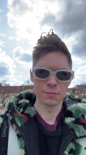 Person films selfie content in Vilnius town square