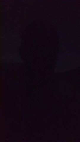 The video is extremely dark, with only faint, indistinct smudges of light appearing and disappearing. No people, objects, actions, interactions, or environmental details are discernible due to the lack of illumination.