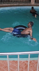 Swimming pool recreation observed with inner tube floating