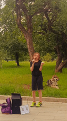 Street performer sings in Moscow park near metro station