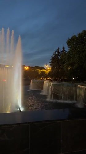 Evening at Saint Petersburg's fountain plaza, kids playing in the light
