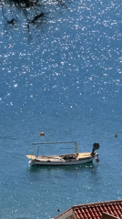 Small boat anchored in calm Adriatic waters near Petrovac
