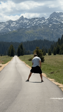 Man performs backflips on mountain road in Montenegro