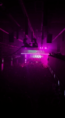 Moscow nightclub hosts large crowd under purple lighting system