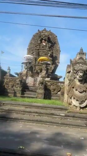Traditional Balinese temple with checkered cloth documented in Sukawati