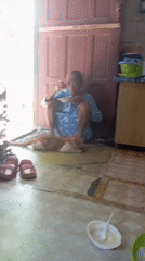 Elderly woman shares morning meal with cat in Baron