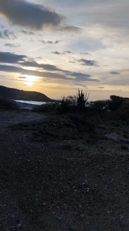 Sunset documented over Juan Griego coastal road and colonial buildings