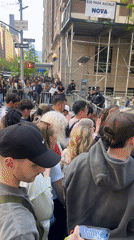 Crowd gathers behind barriers as celebrity escorted in NYC