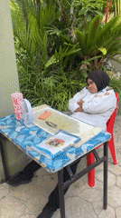 Security guard rests in Kuala Lumpur park setting