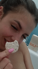Woman documents bath bomb experience in bathroom selfie session