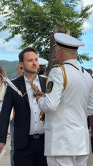 Marching band parades through Budva streets with majorettes