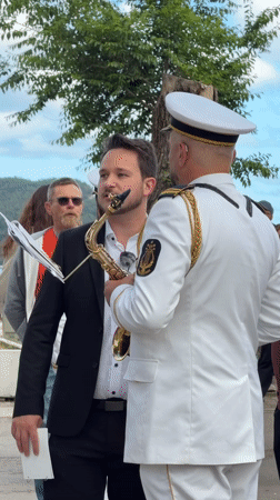 Marching band parades through Budva streets with majorettes