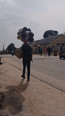 Pedestrians walk streets in Kaduna during afternoon hours