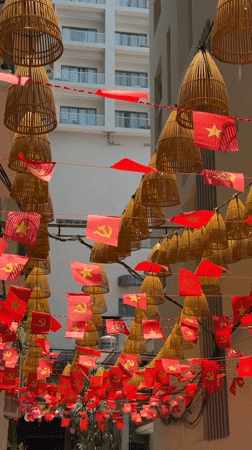Red Communist Party flags decorate urban area in Nha Trang