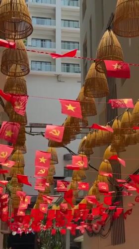 Red Communist Party flags decorate urban area in Nha Trang