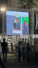 Outdoor screen in Gaza broadcasts a formal public address