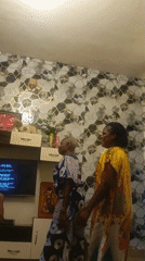 Family gathering features dancing and dining in living room