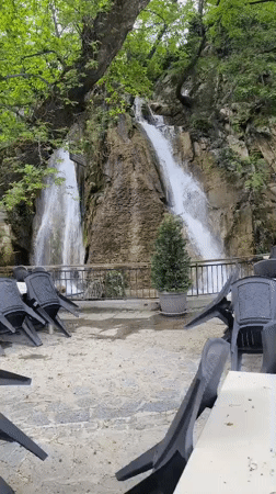 Waterfall scene with seating area captured in Bachkovo, Bulgaria