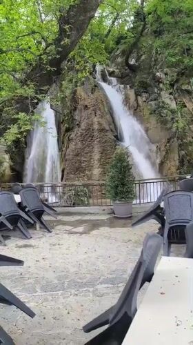 Waterfall scene with seating area captured in Bachkovo, Bulgaria
