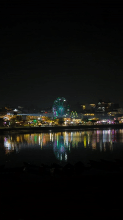 Nighttime scenes in Pokhara feature lit Ferris wheel, street dancing