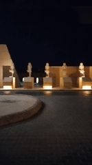 Illuminated Egyptian monuments and statues observed at night display